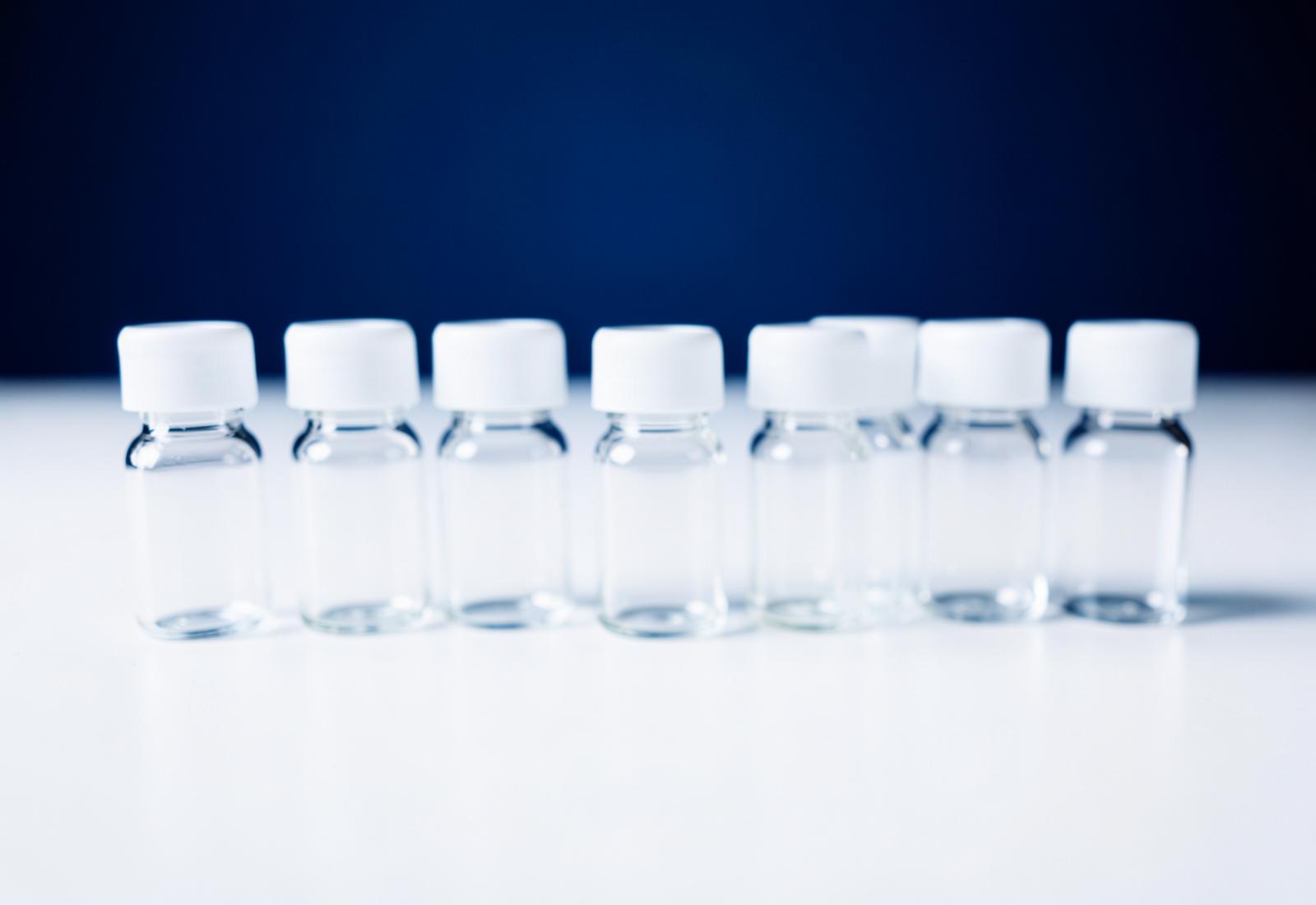 Row of sealed laboratory vials on a white surface